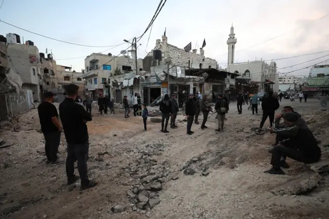 Palestinians inspect a damaged area inside the Jenin refugee camp following an Israeli raid - 9 November 2023