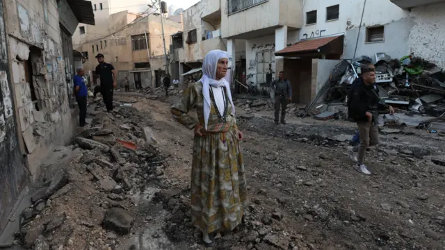 Palestinians stand at a damaged area inside the Jenin refugee camp following an Israeli raid, in the West Bank city of Jenin, 09 November 2023. According to the Palestinian Health Ministry, two Palestinians were killed by Israeli fire close to Bethlehem and Hebron, respectively. Since 07 October 2023, more than 160 Palestinians have been killed, while over 2,000 have sustained injuries in the West Bank.