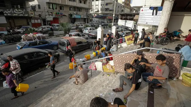 Palestinian people who fled their homes gather at the Al-Quds hospital following Israeli airstrikes in Gaza City, 31 October 2023