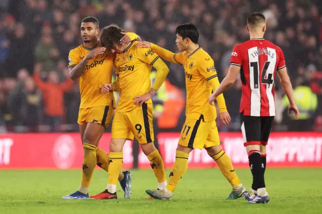 Fabio Silva (second from left) is consoled by team-mates