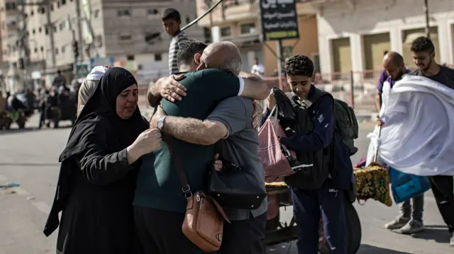 A family embrace as some evacuate to the southern Gaza Strip