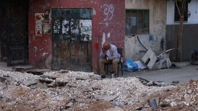 A Palestinian man sits at a damaged area inside the Jenin refugee camp following an Israeli raid, in the West Bank city of Jenin, 09 November 2023. According to the Palestinian Health Ministry, two Palestinians were killed by Israeli fire close to Bethlehem and Hebron, respectively. Since 07 October 2023, more than 160 Palestinians have been killed, while over 2,000 have sustained injuries in the West Bank.