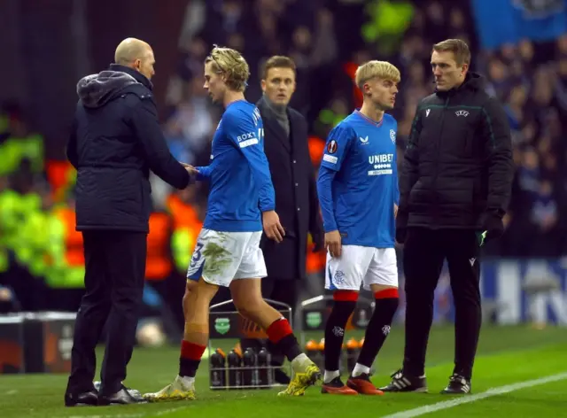 Rangers manager Philippe Clement shakes hands with Todd Cantwell as Ross McCausland waits to replace him