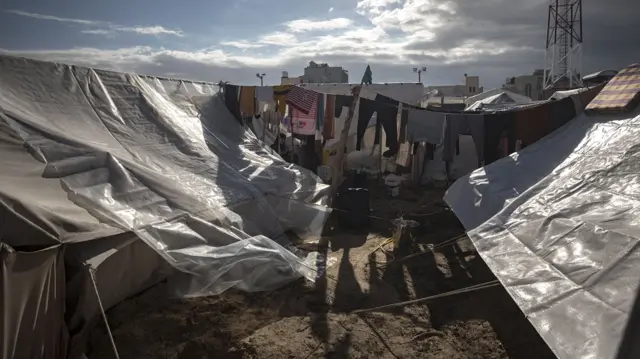 File image of tents with a line of washing hanging between them