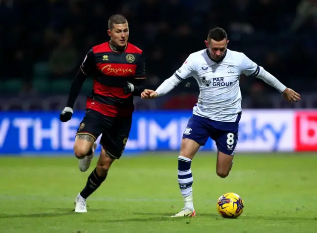 Preston's Alan Browne (right) is tracked by Lyndon Dykes of QPR