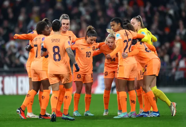 Dutch players huddle together before kick off.