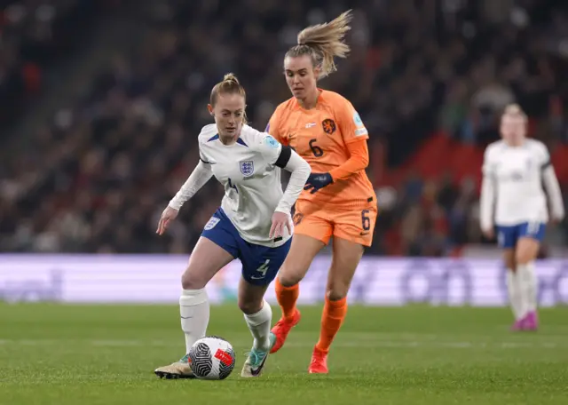 Walsh dribbles the ball in midfield.