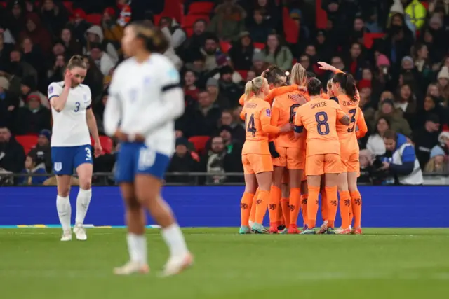 Dutch players celebrate as England players stand stunned.