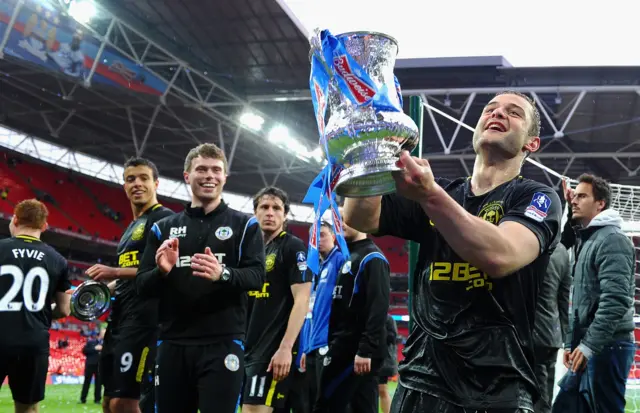 Shaun Maloney raises the cup to the Wigan fans during his lap of honour with the team at Wembley