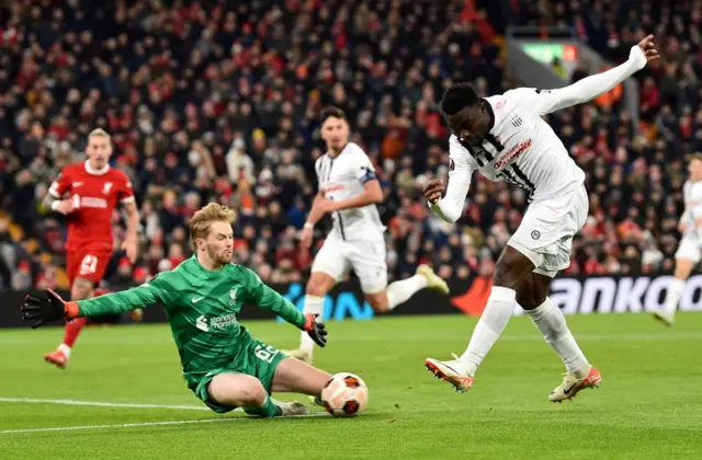 Liverpool goalkeeper Caoimhin Kelleher saves a shot from Ibrahim Mustapha of LASK