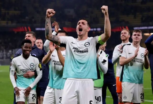 Lewis Dunk celebrates with his Brighton team-mates