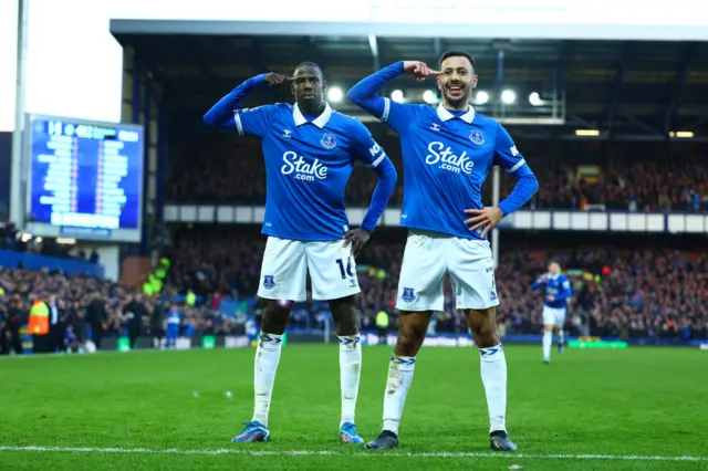 Abdoulaye Doucoure celebrates scoring the opening goal with team-mate Dwight McNeil