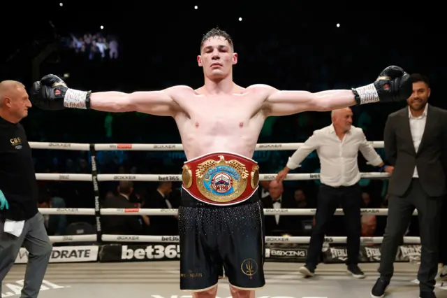 Chris Billam-Smith celebrates with his belt around his waist