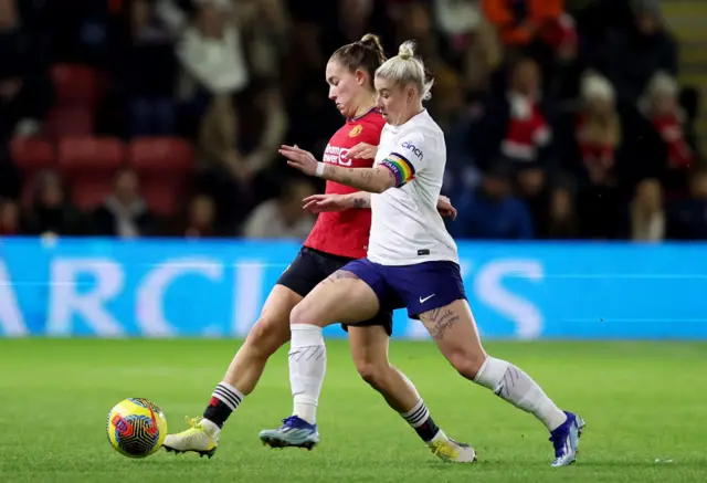 Beth England challenges Maya Le Tissier for the ball.