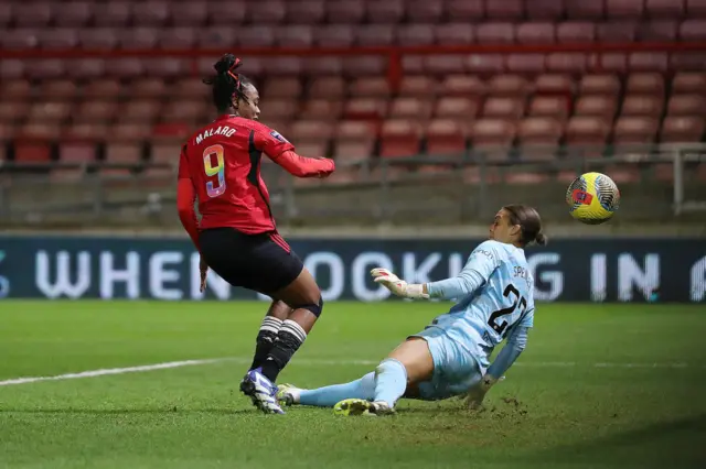 Malard gets a small touch on the ball to divert it past the keeper.