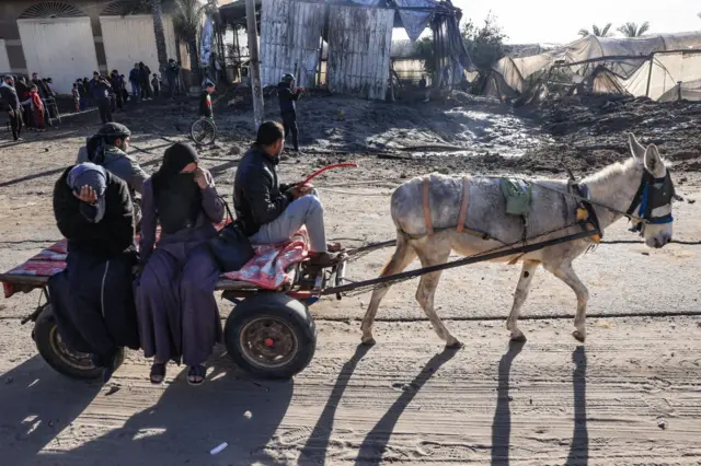 Palestinians travelling by a donkey-pulled cart