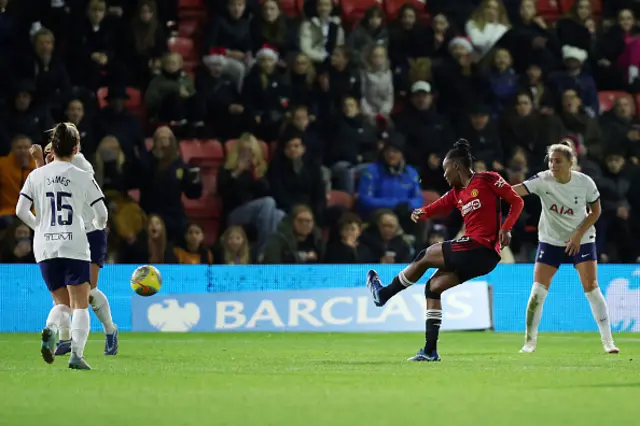 Melvine Malard shoots from the edge of the box as Tottenham defenders look on