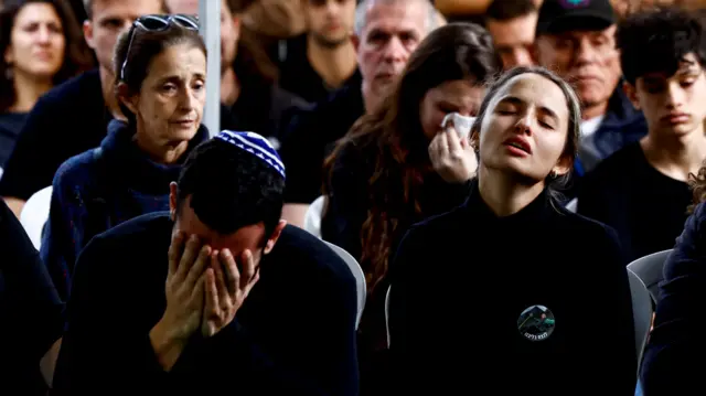 People mourn in Tel Aviv during a funeral