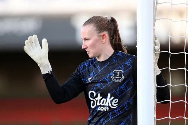 Courtney Brosnan gestures during the game, standing next to the post