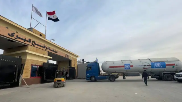 A fuel tanker waits to cross at the Egyptian side of the Rafah border crossing with Gaza on 10 December 2023