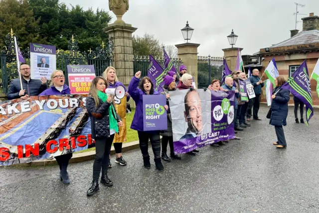 Health workers protested outside the talks at Hillsborough Castle