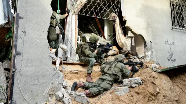 Israeli soldiers operating in the Shajaiya district of Gaza City on Sunday