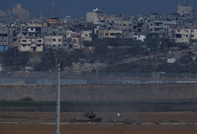 A tank patrols an area in the Gaza Strip