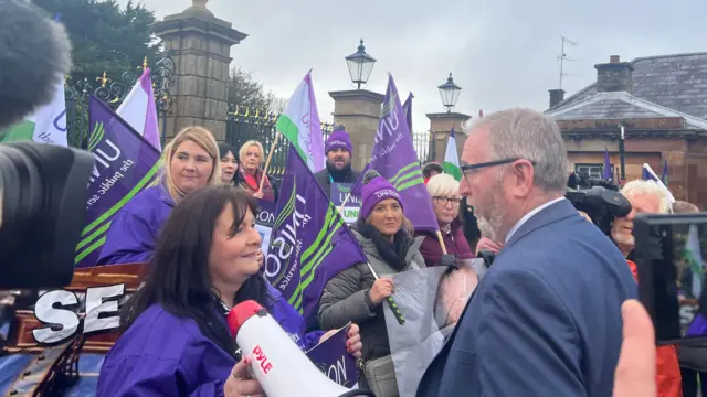 Doug Beattie talking to protesters at Hillsborough Castle