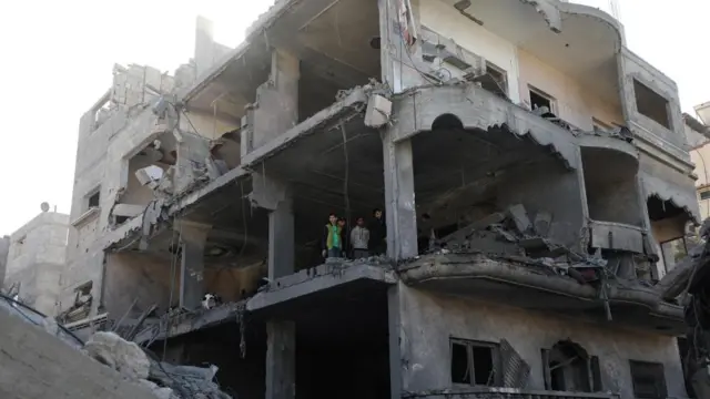 Palestinians inspect the rubble of the destroyed house of the Al Madfaa and Shabit families following Israeli airstrikes on Al Maghazi refugee camp, southern Gaza Strip, 11 December 2023.