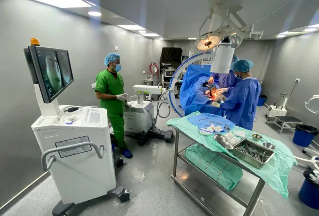 Medics operate on a patient at Al-Awda hospital in northern Gaza. Photo: November 2023