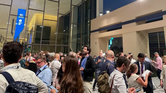 Journalists huddling outside the media centre in Dubai