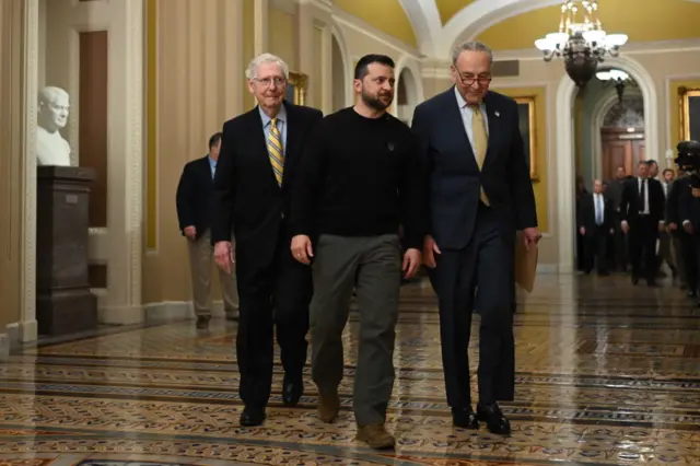 Ukrainian President Volodymyr Zelensky is accompanied by US Senate Majority Leader Chuck Schumer and Minority Leader Mitch McConnell as he arrives to meet with members of the US Senate on Capitol Hill