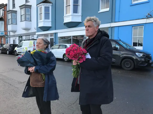 Members of community group with flowers