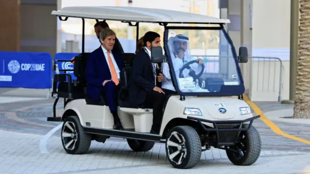 John Kerry travelling on a golf buggy