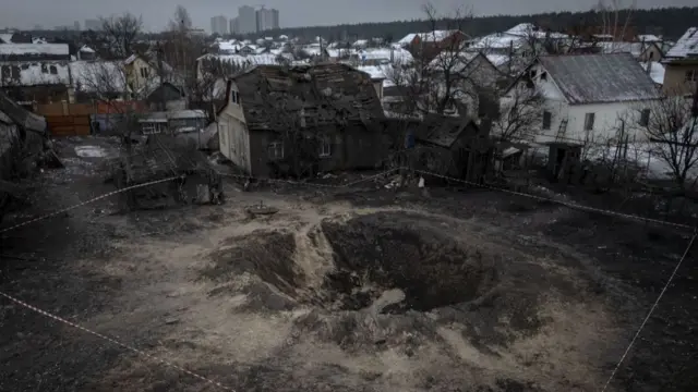 An aerial view of a pit and the damage around it caused by a ballistic missile attack by the Russian army on 11 December in the Darnitsa district of Kyiv, Ukraine on 12 December 2023.