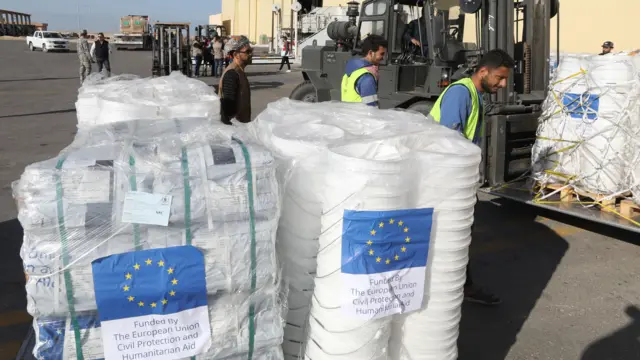 People unload humanitarian aid destined for the Palestinians in Gaza.