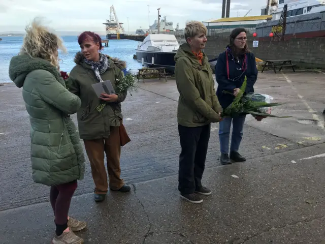 Members of community group with flowers