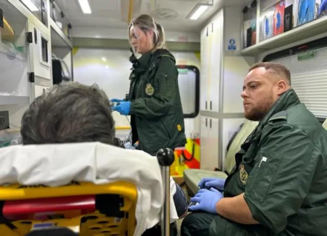 Paramedics with patient in ambulance
