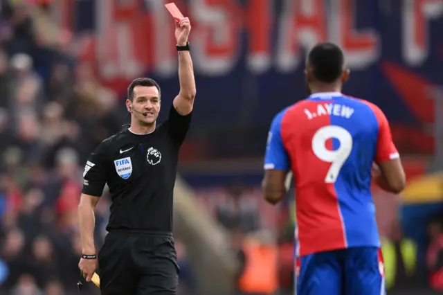 Referee Andy Madley gives Jordan Ayew a red card