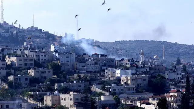 Smoke rises over residential buildings at the Jenin refugee camp during a raid by the Israeli forces