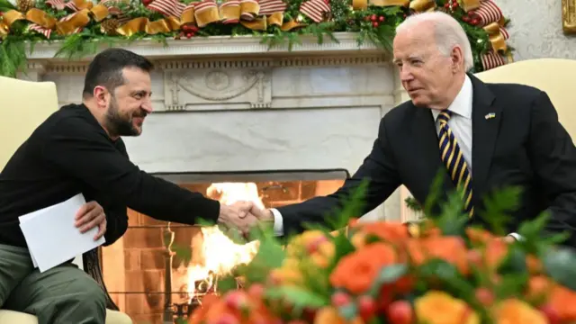 US President Joe Biden shakes hands with Ukrainian President Volodymyr Zelensky during a meeting in the Oval Office of the White House in Washington, DC