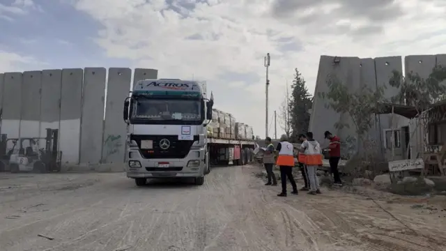 Palestinian Red Crescent team receives a humanitarian aid truck at a location given as the Rafah border crossing between Egypt and the Gaza Strip