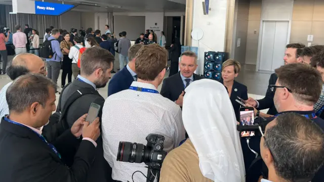 Reporters gather around to interview a delegate