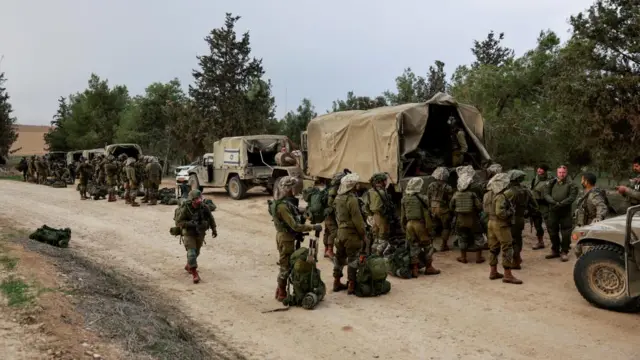 Israeli soldiers gather on the Israeli side near the border with Gaza