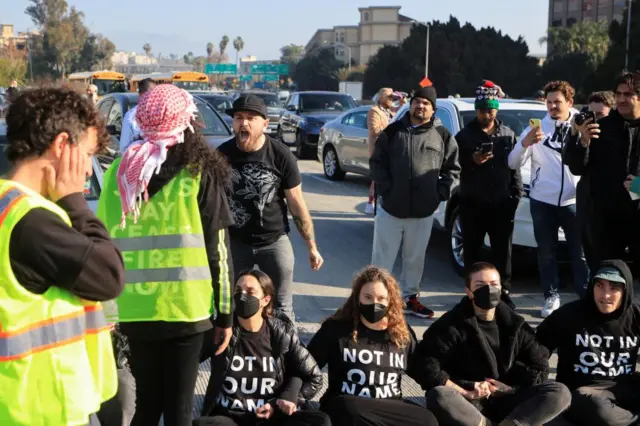 A driver argues with protesters blocking traffic on the 110 Freeway to demand a ceasefire and an end to U.S. support for Israel's attack on Gaza