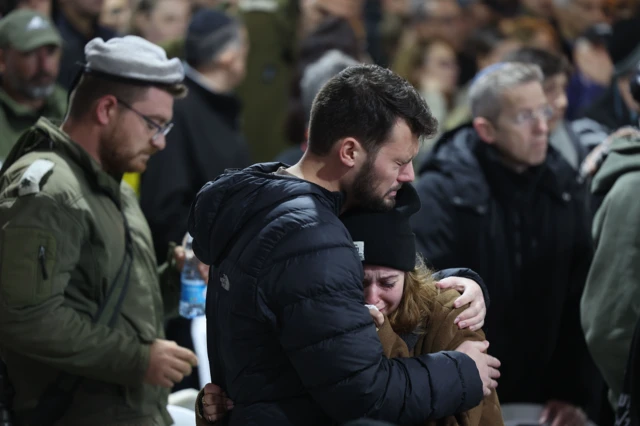 Family of Col Tom Grinberg mourn at his funeral