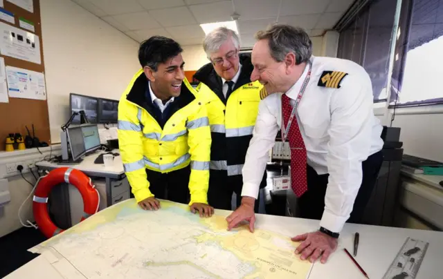 Britain's Prime Minister Rishi Sunak and First Minister of Wales Mark Drakeford with John Goddard harbour master