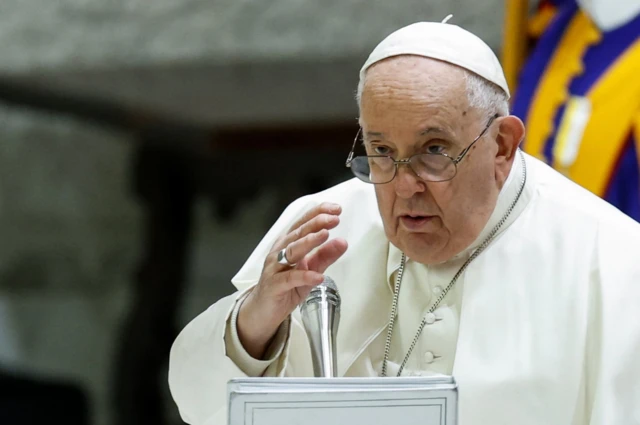 Pope Francis gives a blessing at the end of the weekly general audience