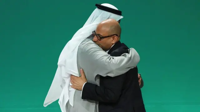 COP28 President Sultan al-Jaber and UNFCCC Executive Secretary Simon Stiell hug.