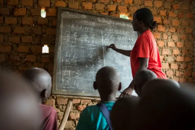 Ugandan teacher teaching math in primary school.